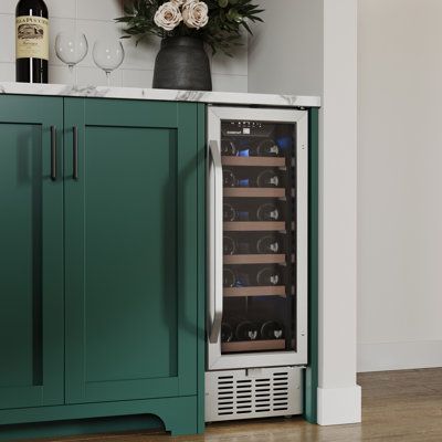 a wine cooler sitting in the corner of a kitchen