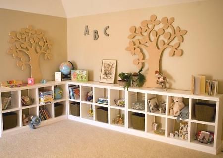 a room with several bookshelves and stuffed animals