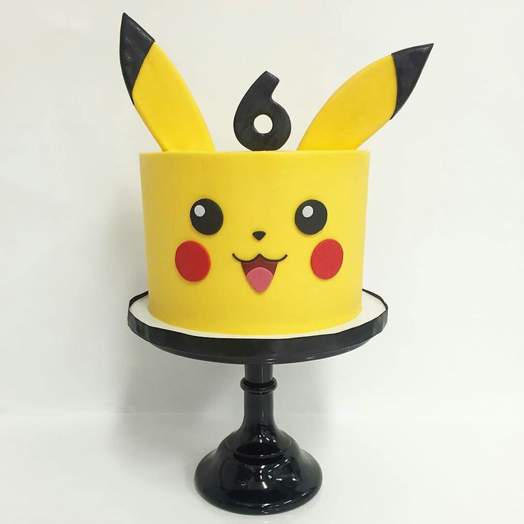 a yellow cake with pikachu ears on it