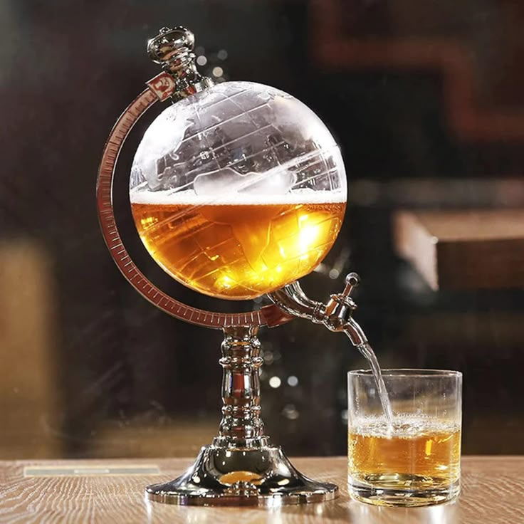 a glass filled with liquid sitting on top of a wooden table