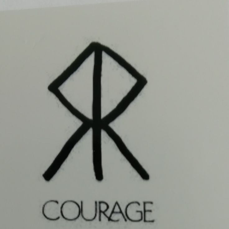 a close up of a logo on the side of a wall with words that read, courage