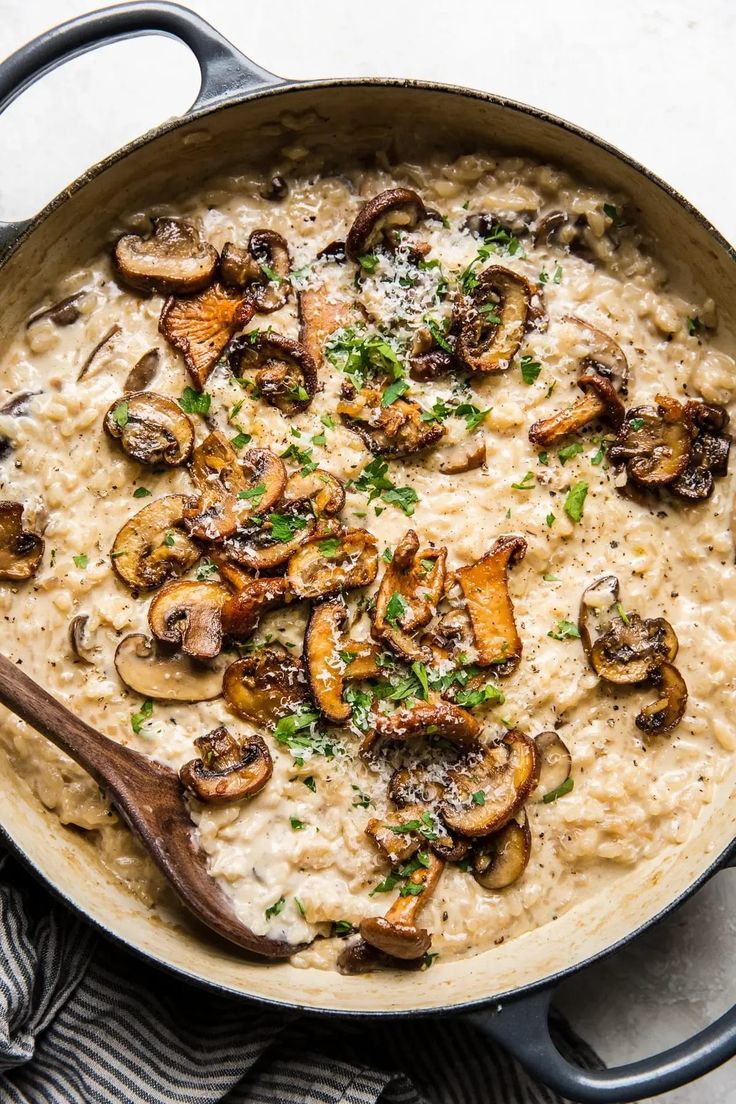 a skillet filled with rice and mushrooms