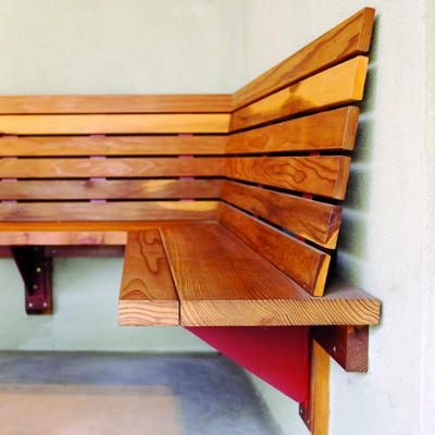 a wooden bench sitting on top of a cement floor