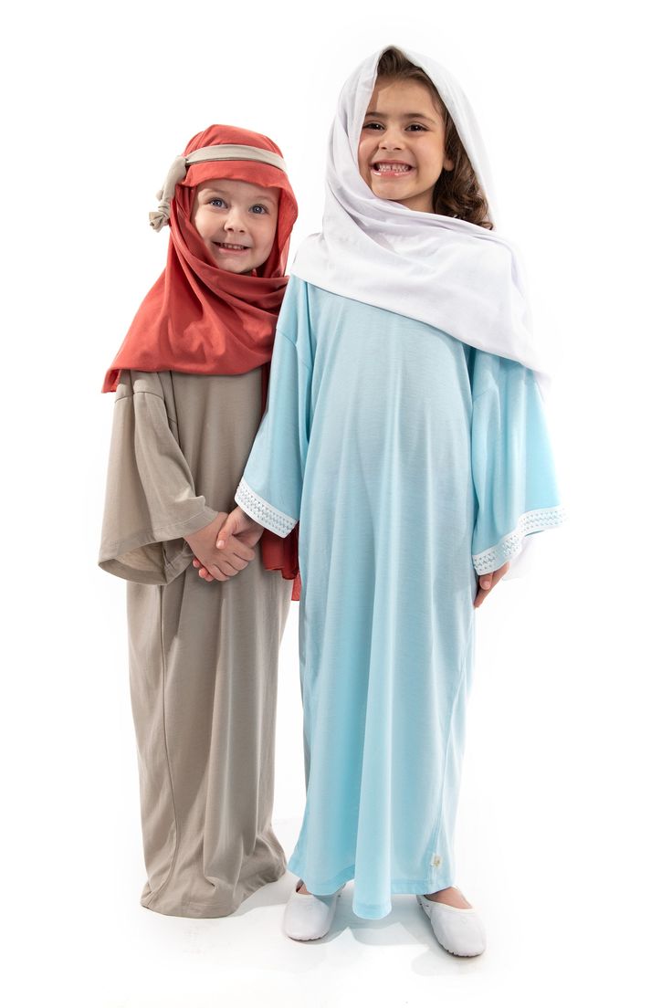 two young children dressed in biblical clothing posing for the camera with their arms around each other