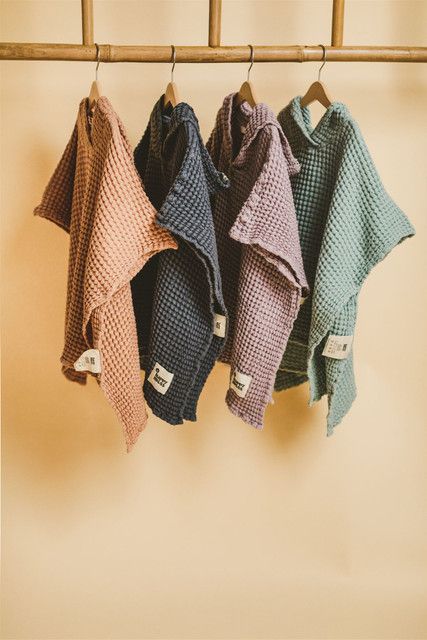 four towels hanging on a clothes rack