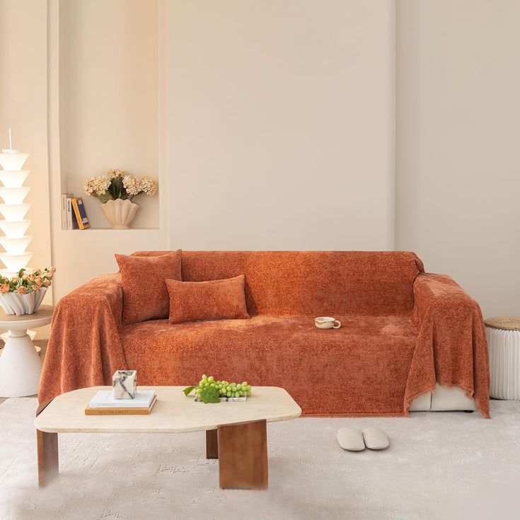 a living room with an orange couch and coffee table