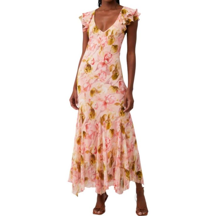 a woman wearing a dress with flowers on it