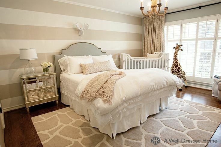 a white bed sitting in a bedroom next to a window