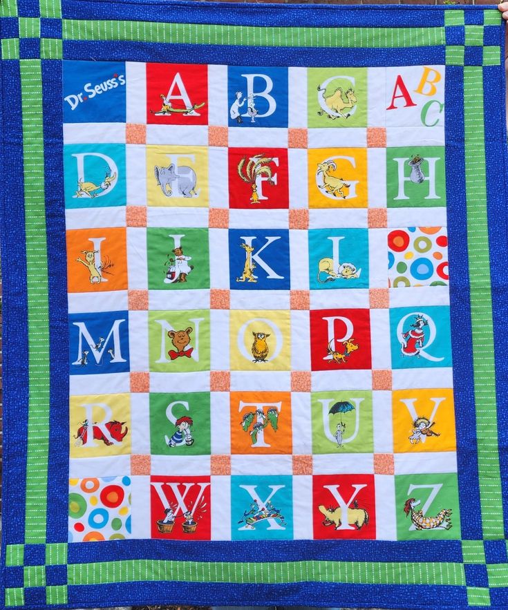 a child's quilt with letters and numbers on it