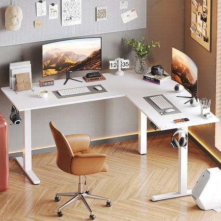 a white desk with a computer on top of it next to a chair and suitcase