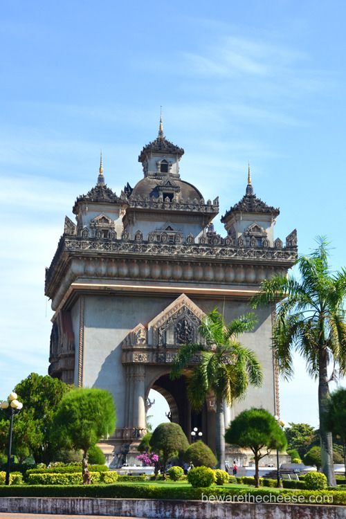 an ornate building with palm trees in the foreground