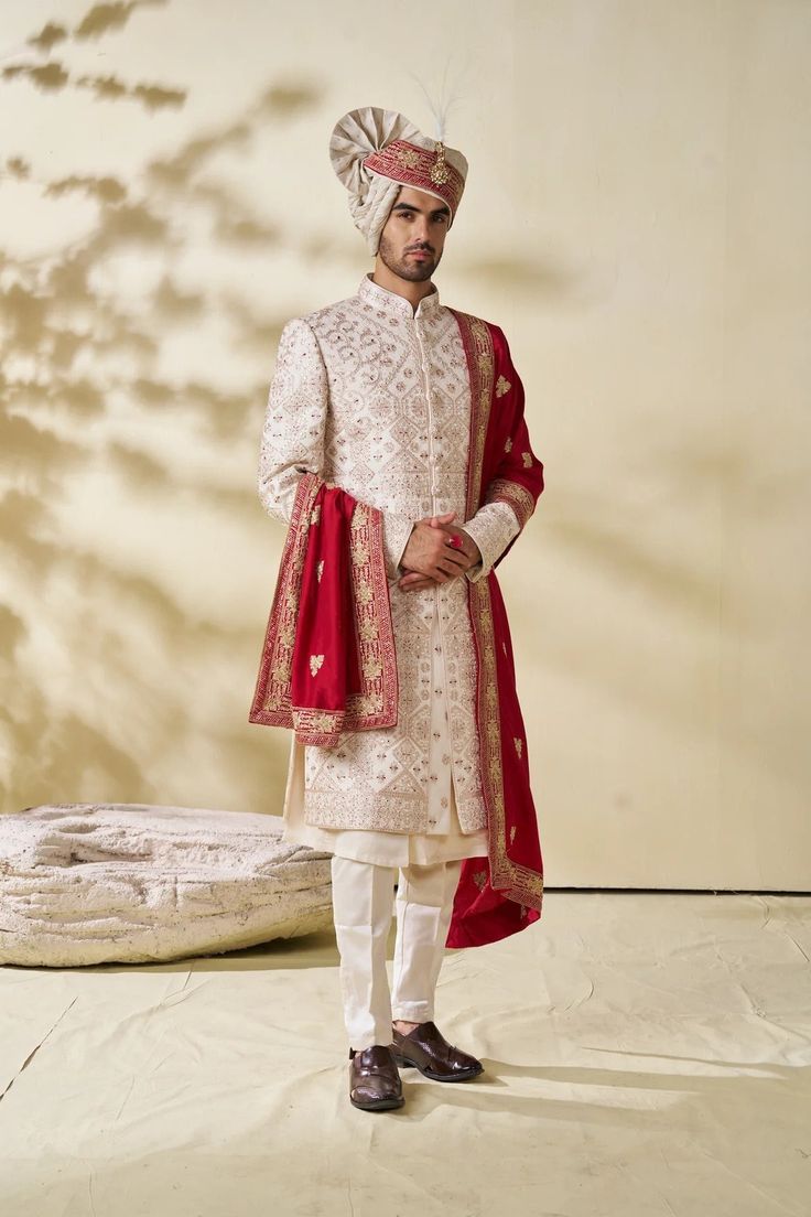 Step into elegance and tradition with our Royal Rosegold Sherwani, a stunning choice for the discerning groom. This designer sherwani blends classic charm with contemporary style, perfect for a memorable wedding day look. Handcrafted with meticulous attention to detail, this sherwani features intricate embroidery and exquisite embellishments, making it a standout piece for any groom. Elevate your wedding attire with this magnificent sherwani, tailored to perfection for a truly regal appearance on your special day. Please note: This is a made-to-measure product. Simply select your approximate chest size when placing your order. Once your order is received, we will contact you to schedule a video call for complete measurements. Cost Includes: Sherwani and Pajama(bottom) only. Accessories lik Men Sherwani Wedding Indian Groom, Men Sherwani Wedding, Gold Sherwani, Sherwani Wedding, Men Sherwani, Indian Groom Dress, Wedding Outfits For Groom, Sherwani Groom, Groom Wedding Dress