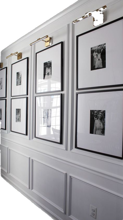 several black and white photos are hung on the wall with gold trim around them,