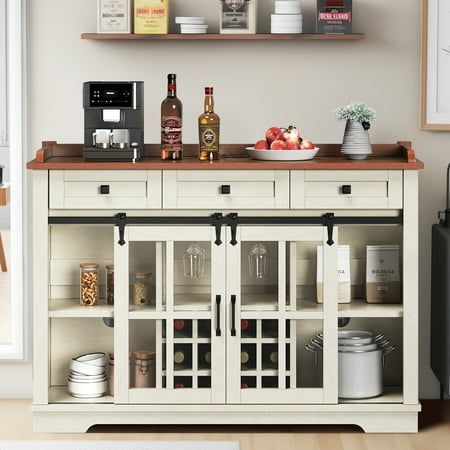 a kitchen with white cabinets and shelves filled with bottles, bowls, cups, and other items