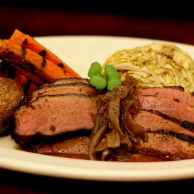 a white plate topped with meat and veggies