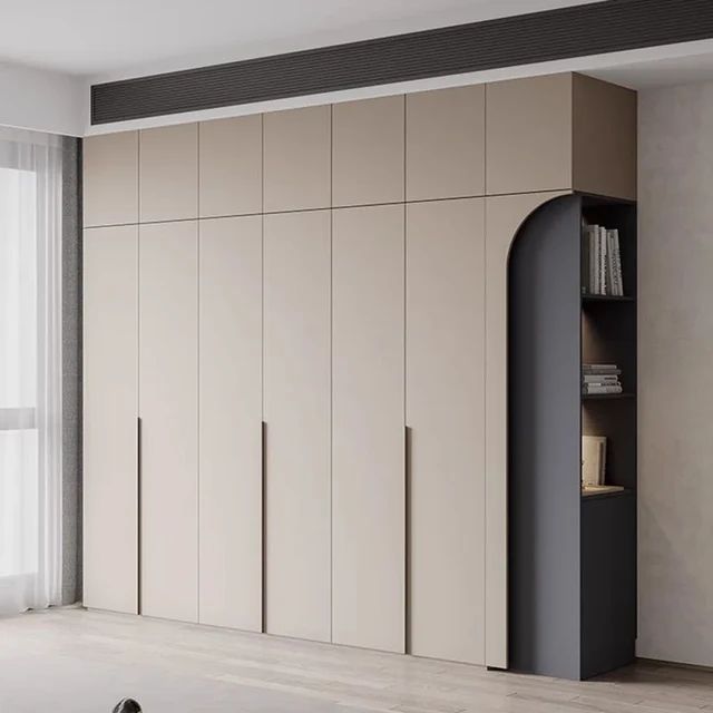 an empty room with white walls and beige cupboards