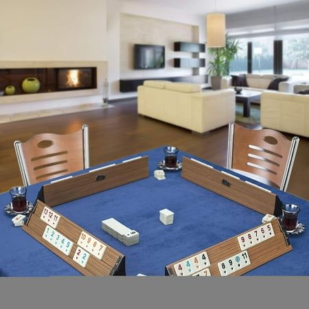 a blue table topped with cards and dominos on top of a hard wood floor