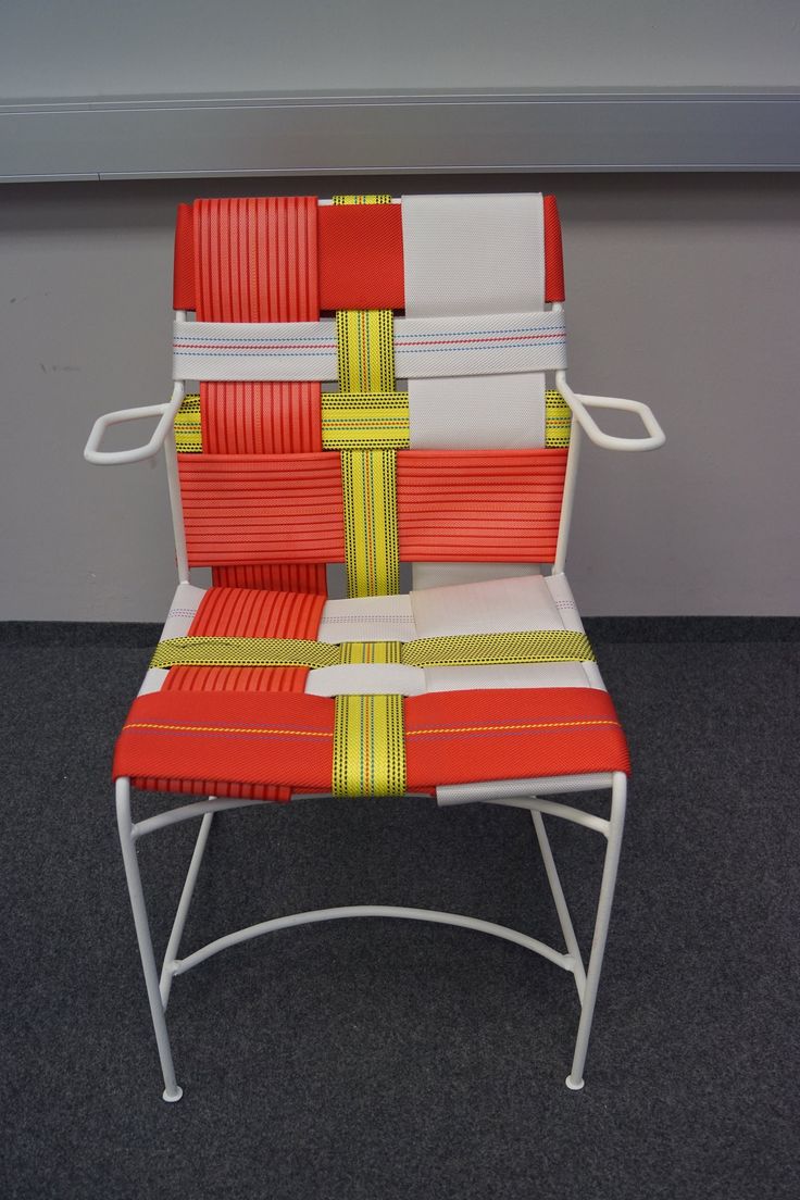 an orange and white chair sitting on top of a carpeted floor