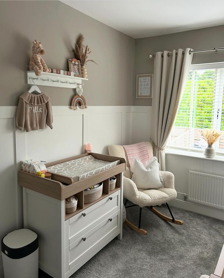 a baby's room with a rocking chair, dresser and crib in it