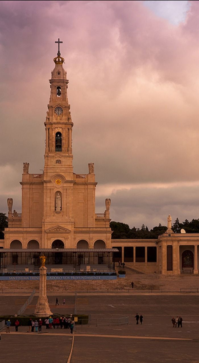 a large building with a clock tower in the middle of it's center square