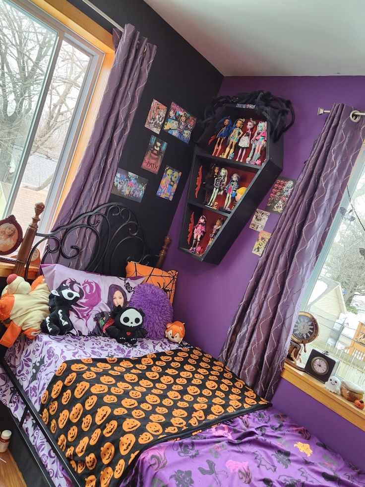 a bedroom decorated for halloween with purple walls