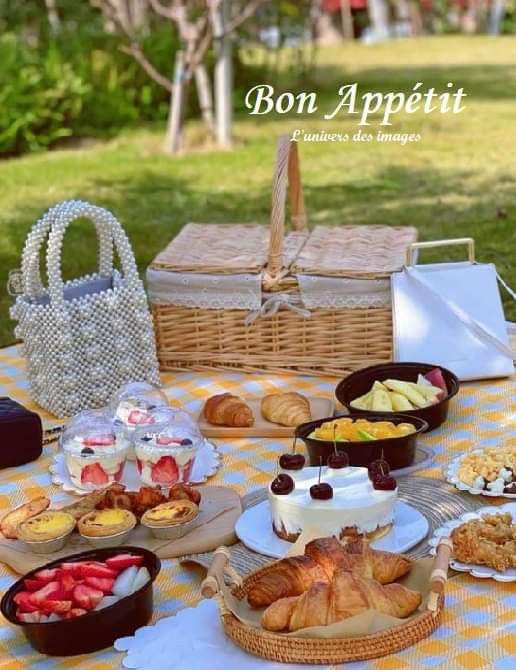 a picnic table with breads and pastries on it