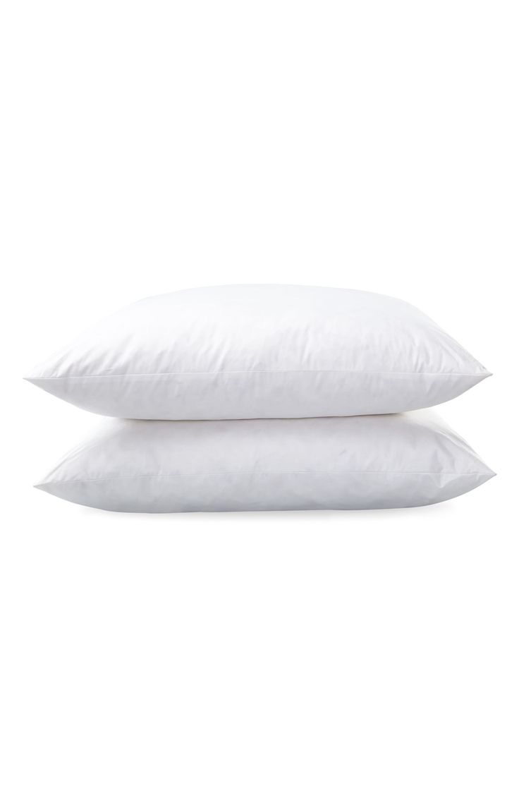 two white pillows sitting on top of each other