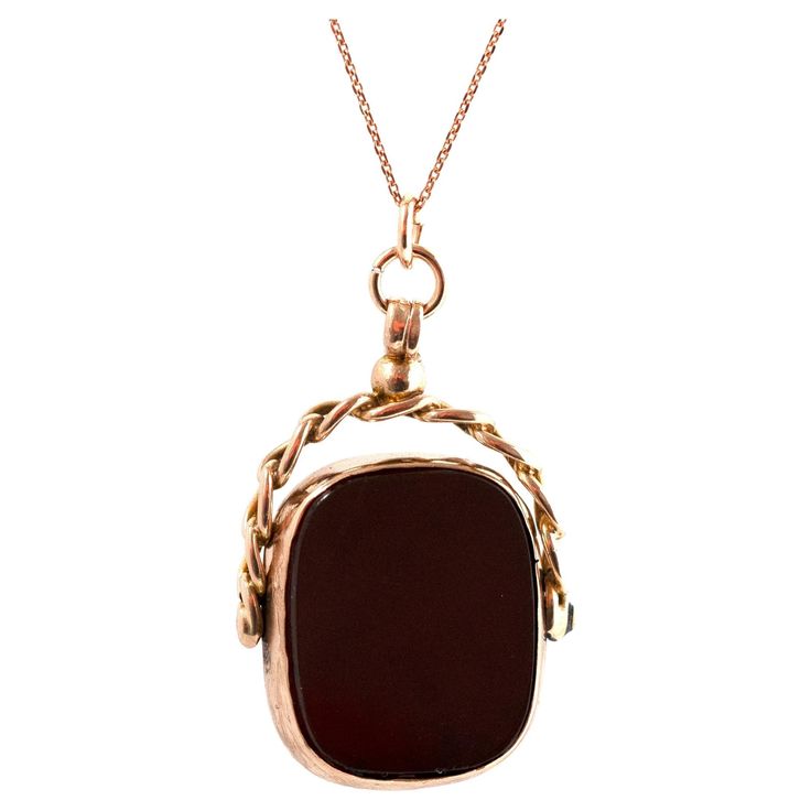 Step back in time with our Antique 1917 Carnelian 9ct Rose Gold Swivel Fob Necklace, a piece that exudes the elegance and charm of the early 20th century. This exquisite pendant features a beautifully polished Carnelian on one side, set in a 9ct rose gold frame. The Carnelian, known for its deep, rich red hue, is elegantly showcased in the swivel fob design, allowing it to move. Crafted in the year 1917, this piece not only represents the exquisite craftsmanship of its era but also serves as a t Antique Rectangular Formal Necklace, Vintage Pendant Necklace, Rose Gold Frame, Chatelaine, Step Back, Timeless Treasures, Back In Time, Early 20th Century, Gold Frame