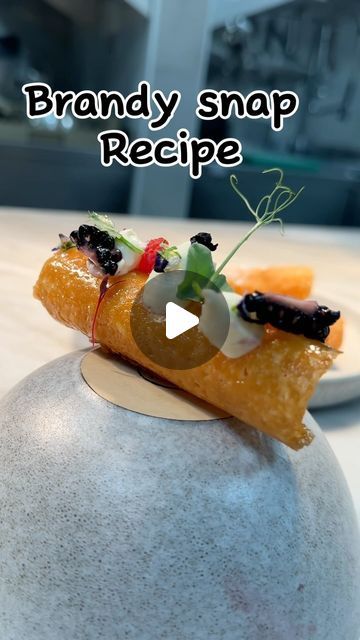 a food item sitting on top of a stone ball with the words brandy snap recipe