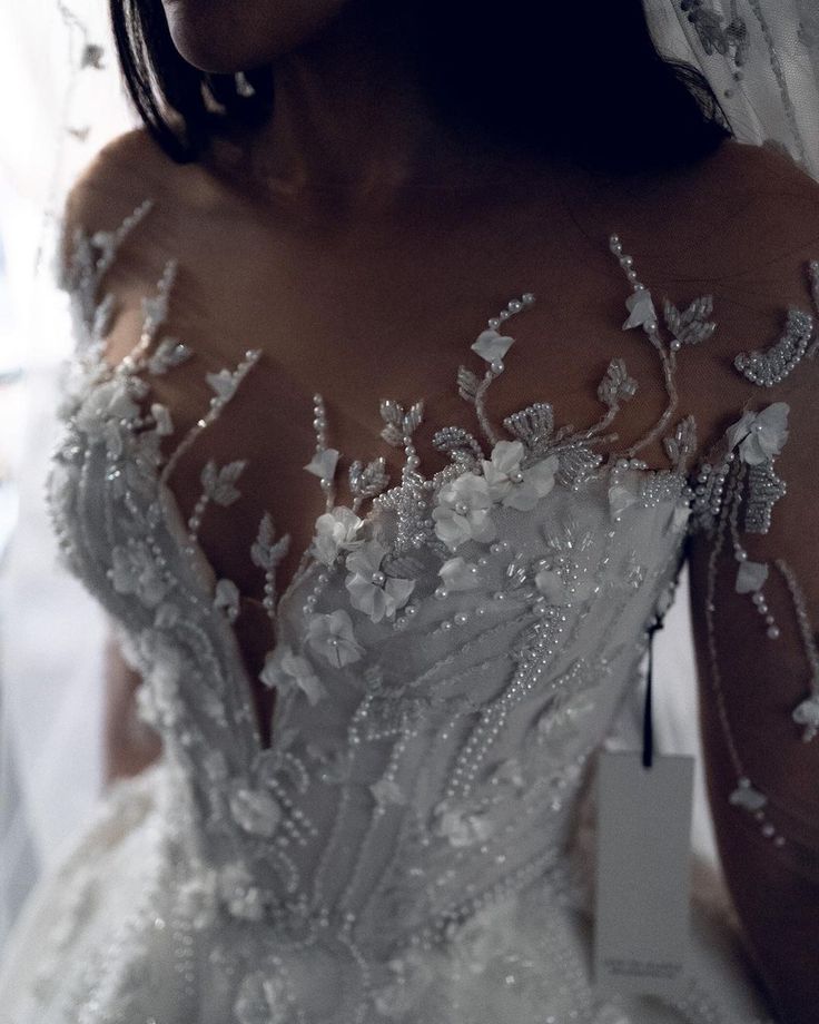 a woman in a wedding dress is posing for the camera