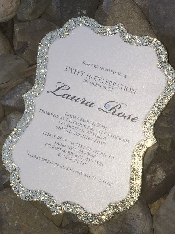 a white and silver wedding card sitting on top of some rocks with the words sweet celebration in it