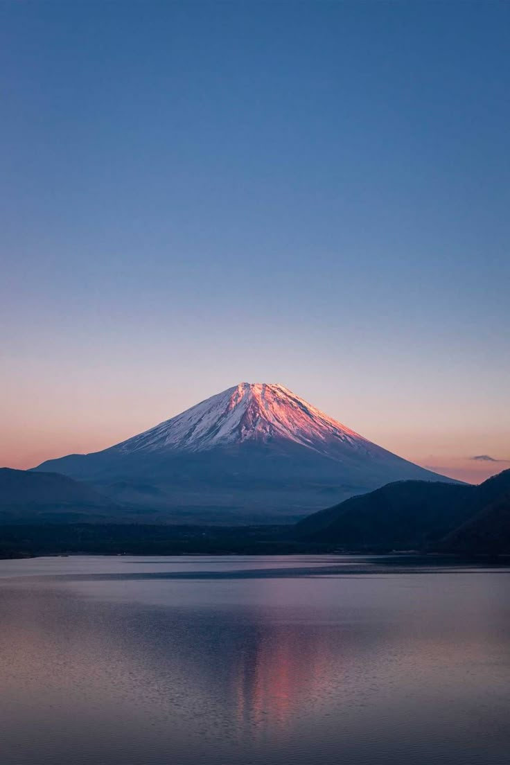 a large mountain sitting on top of a lake