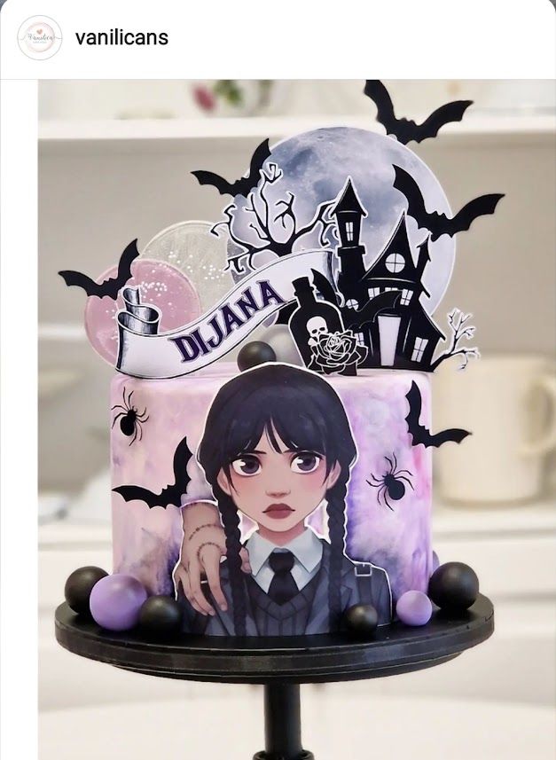 there is a cake decorated with an anime character on the top and bats around it