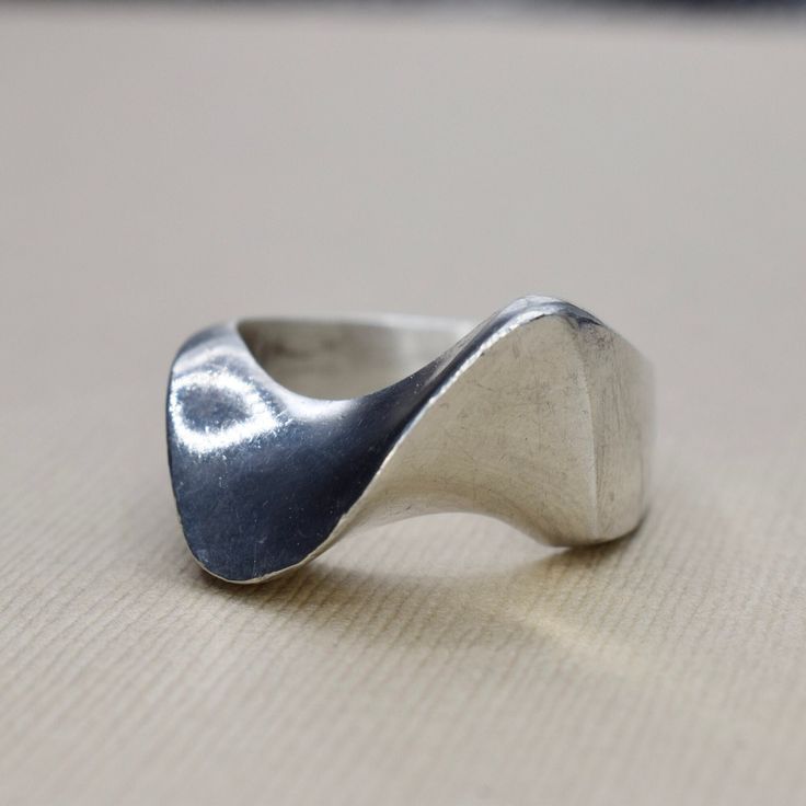 Vintage sterling silver modernist wave design ring. Signed MEXICO. Era: c.1970s Markings: MEXICO 925 Material: Sterling Silver Ring Size: 9.5 (Comes with one free resizing by our jeweler) Weight: 15.1 grams Condition: Good vintage condition with minor surface wear from age  Shipping is free in the United States  Follow us on Instagram @LUXXORVintage Wax Casted Jewelry, Modernist Sterling Silver Rings, Modern Silver Wavy Rings, Modern Wavy Rings With Polished Finish, Modern Wavy Jewelry For Anniversary, Modern Jewelry For Anniversary, Wave Rings, Silver Ring Design, Rabbit Ring