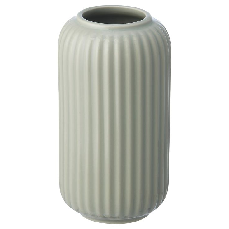 a large white vase sitting on top of a table