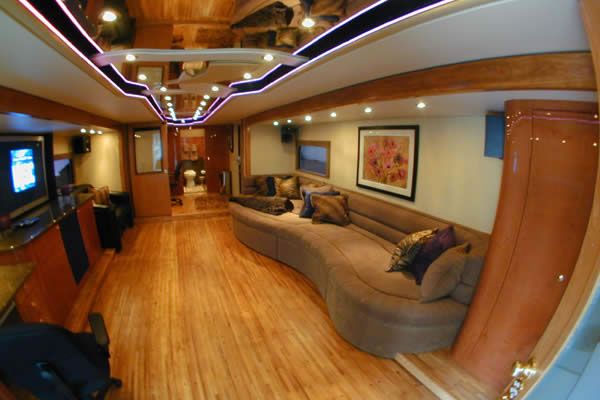 a fisheye lens view of a living room with couches, television and entertainment center