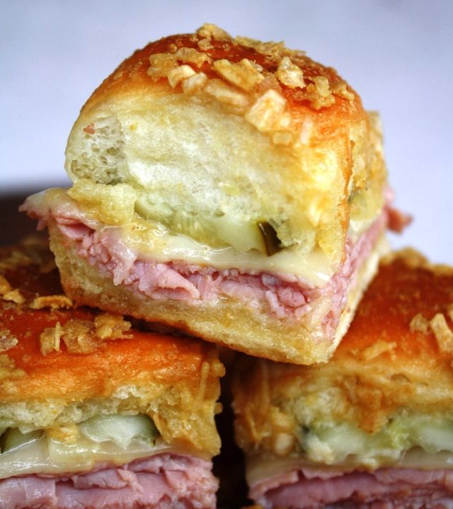 ham and cheese pastrami sandwiches stacked on top of each other with melted cheese