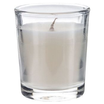 a white candle in a glass on a white background