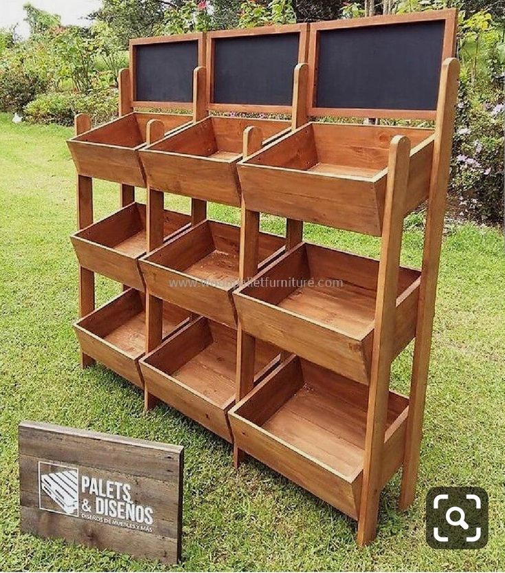 a wooden shelf with chalkboard on the top and two empty bins below it