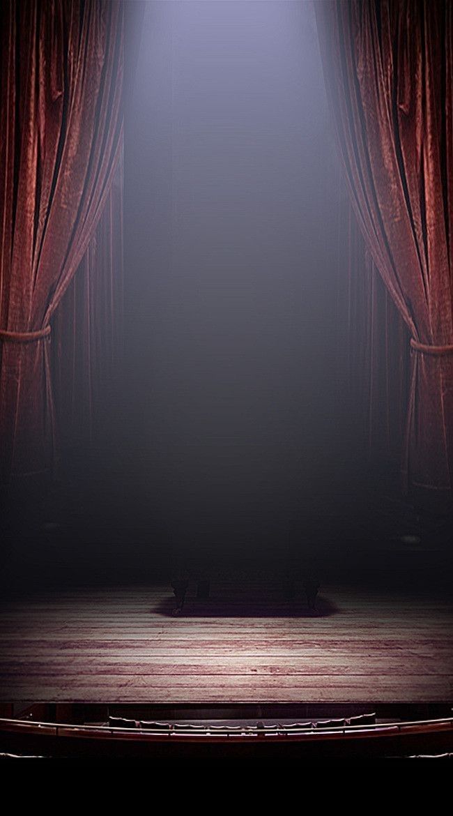 an empty stage with red curtains and a wooden floor