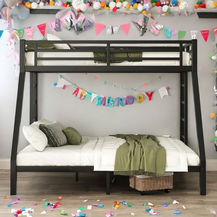 there is a bunk bed with a birthday banner on the wall above it and confetti everywhere around