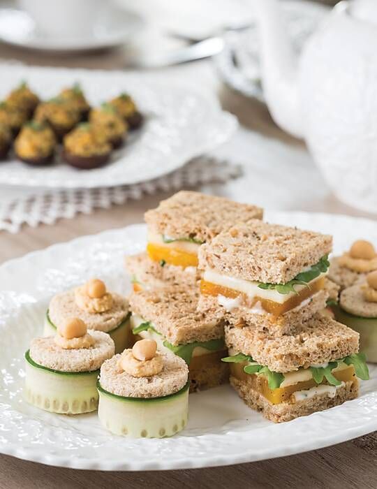 a white plate topped with sandwiches and cucumbers