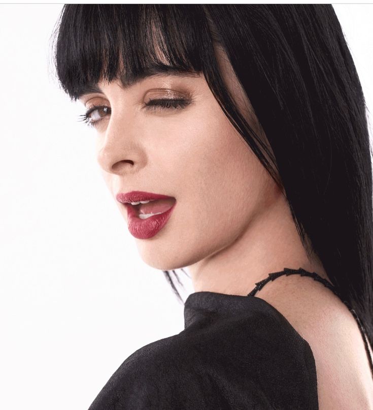 a woman with black hair and red lipstick