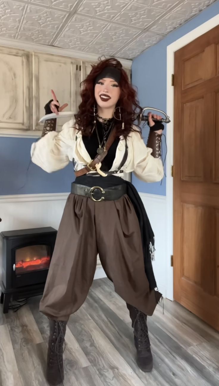 a woman dressed in pirate costume posing for the camera