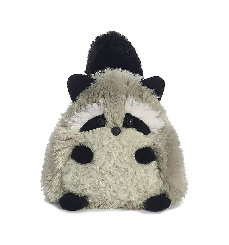 a raccoon stuffed animal sitting on top of a white floor next to a black hat