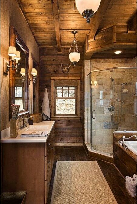 a large bathroom with wooden walls and ceiling, along with a walk - in shower