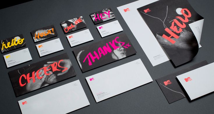 various stationery items are displayed on a black surface with pink and orange lettering that reads thank