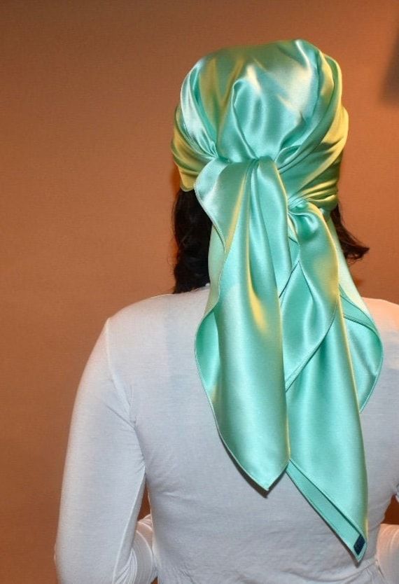 Alessia silk head wrap is a beautiful sea foam green charmeuse silk sleep scarf which will protect your hair from frizz and retain its moisture while you sleep. Swap out your traditional bonnet for a chic silk sleep scarf. Silk scarves will protect your hair from the friction of a cotton pillowcase, which can cause damage to your beloved tresses! Fabric Fun Facts !   Silk Benefits: 1. Silk has a natural protein structure and is the most hypoallergenic of all fabrics 2. Silk is an all-climate fabric making it suitable for the any season 3. Sleeping on silk will preserve your hairstyles longer and prevent frizz 4. Sericin  proteins in silk protects delicate hair  5. Silk is a lightweight and breathable fabric 6. Gentle material soothes skin and prevents irritation of sensitive skin  Details: Hair Covers Head Wraps, Silk Scarf Head Wrap, Sleep Scarf, Silk Headwrap, Scarf Head Wraps, Mulberry Scarf, Protein Structure, Silk Hair Wrap, Bandana Silk