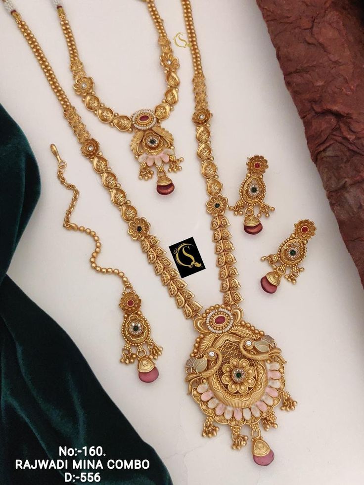 Description :- Long Choker Indian Traditional Wedding Bridal Wear Gold Plated Necklace Earrings Tika Kundan Diamond Fashion Jewelry Set 2 Piece Combo Set The biggest highlight of this manalis necklace set lies in its detailing. The designers at Tarinika have put meticulous attention to details in order to perfect the detailing of the unique and intricate design. The bead-like design of the necklace's chain fuses ethnic style with contemporary flairs. 100% Satisfaction Guarantee: 1 Year Warranty, Gold Jewelry Fashion Necklace Long, Luxury 22k Gold Jewelry Sets With Intricate Design, Luxury 22k Gold Temple Bridal Necklace, Gold Peacock Design Jewelry Sets For Weddings, Temple Jewelry Sets With Peacock Design For Weddings, Gold Set Design, Indian Traditional Wedding, Necklace Set Indian Bridal Jewelry, Antique Gold Jewelry Indian