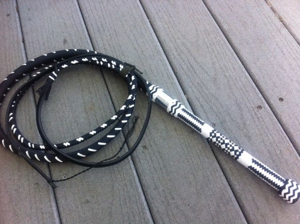 a black and white leash laying on top of a wooden floor